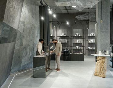 interior of jewelry boutique with buyer and shop assistant